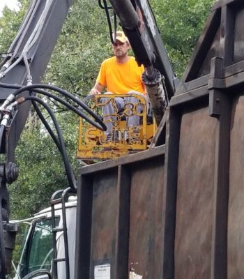 Owner Dunstin Darroll operates the grapple truck to load up debris.