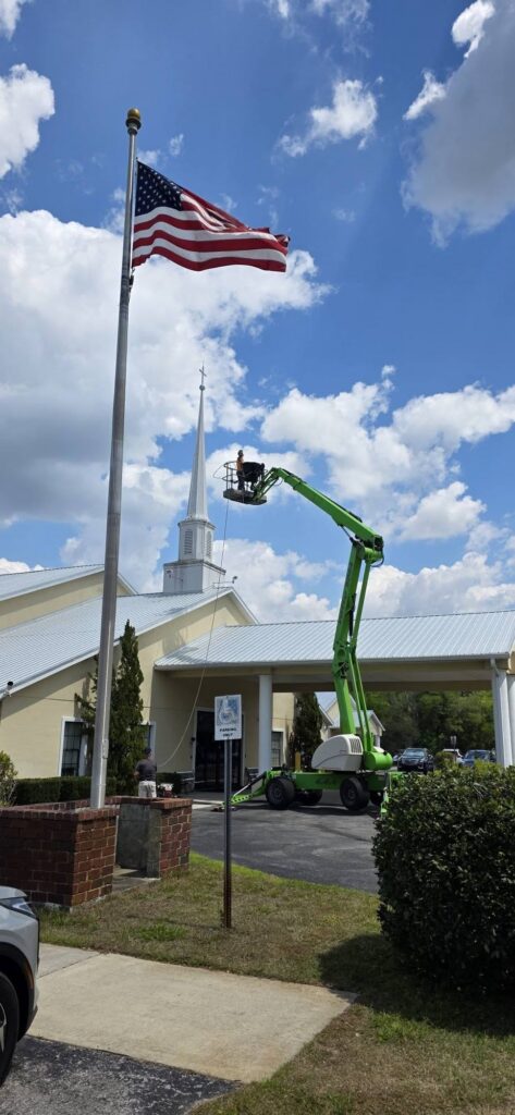 Lift truck used to pressure wash first united methodist church - boom lift services in dunnellon