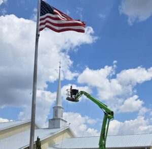 Lift truck used to pressure wash first united methodist church - boom lift services in dunnellon