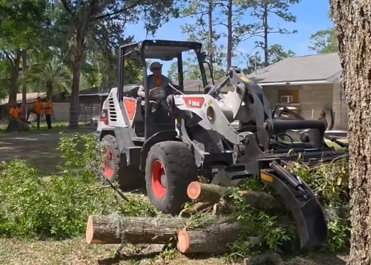 The ground crew start to clean up the debris from the emergency tree limb removal